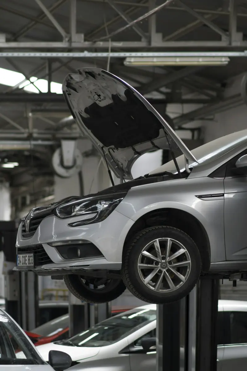 Car raised on a lift for inspection in a repair shop